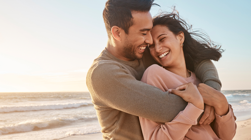 Nundah General and Emergency Dental Two women smiling and laughing while hugging each other outdoors.